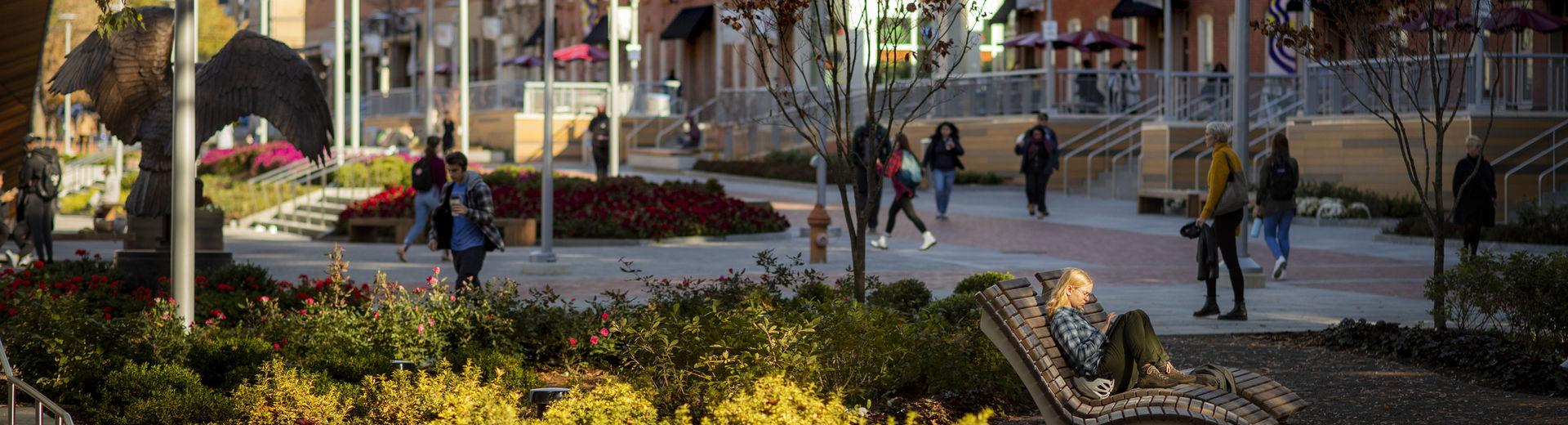 Students walking through O'Connor Plaza on a sunny fall day